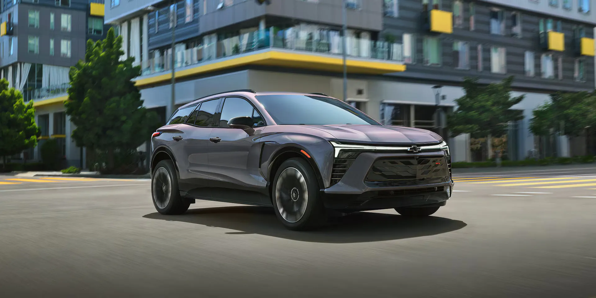 A gray blazer ev driving on the road.
