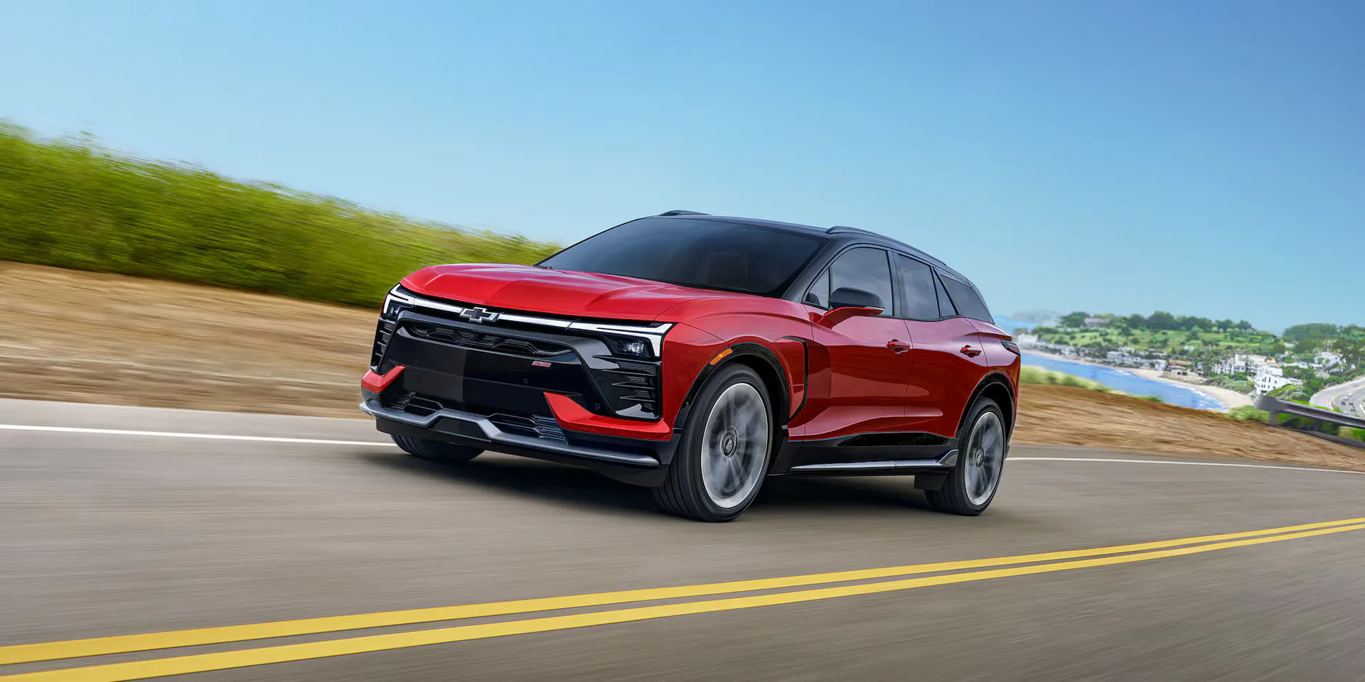A red blazer ev driving on the road.