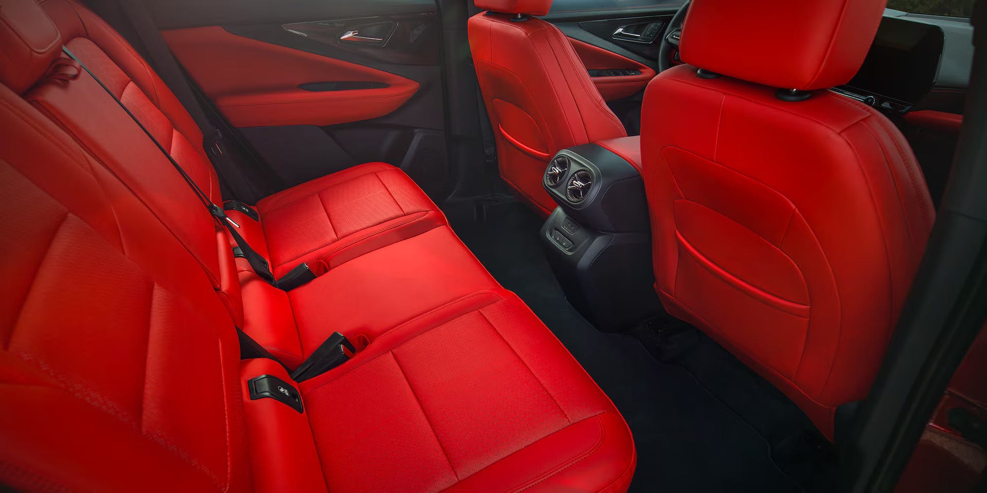 backseat of blazer ev showcasing red interior seats