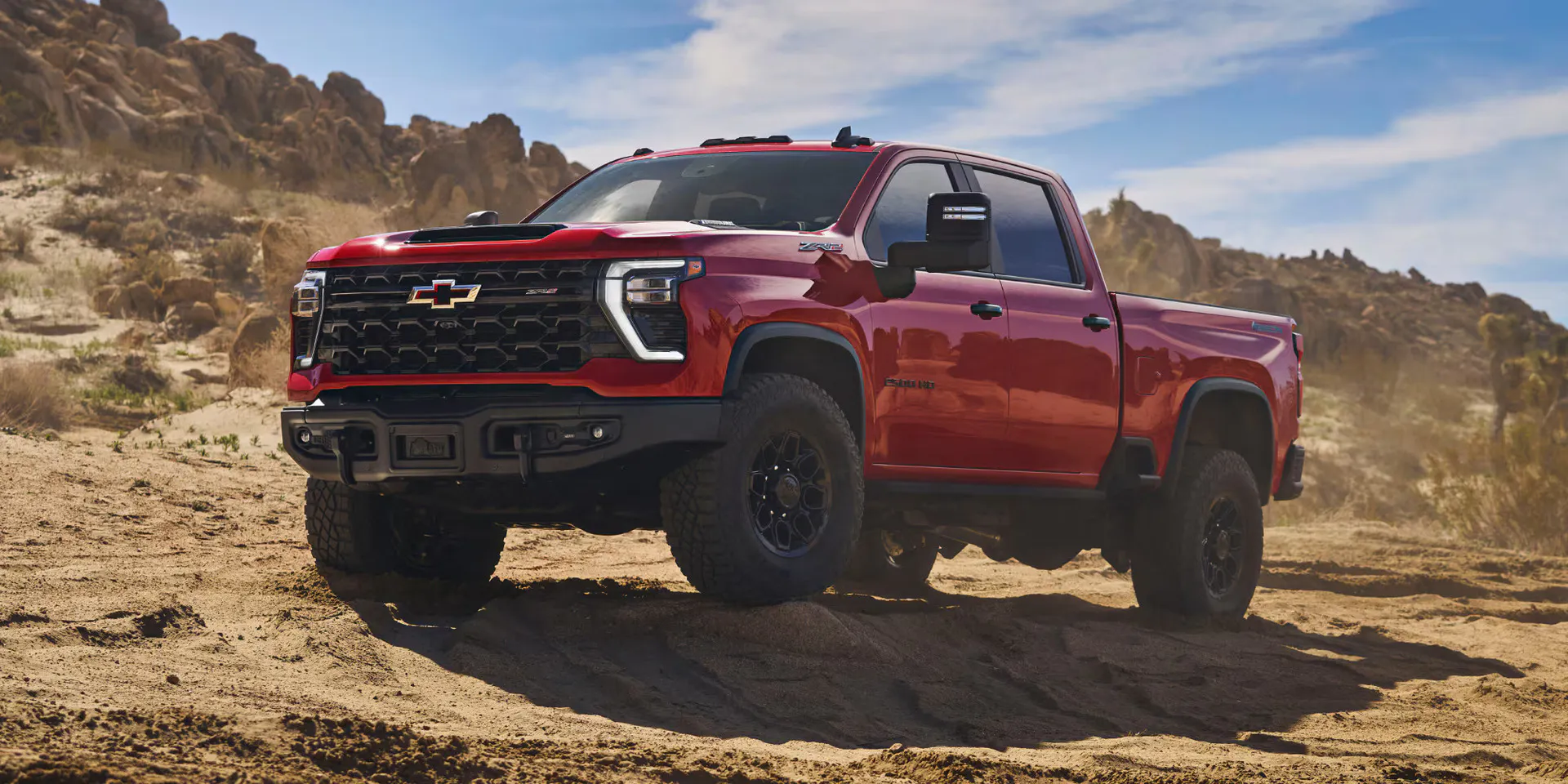 a new 2026 chevy silverado hd parked next to a rocky hill