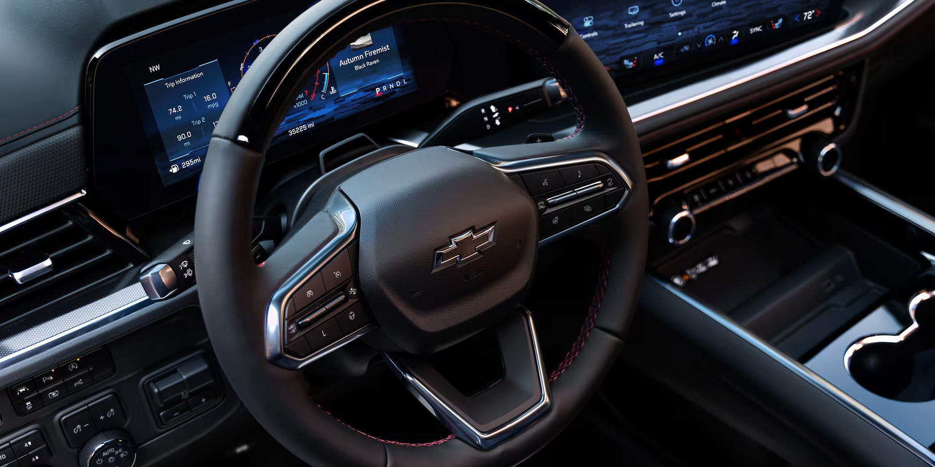 view of the steering wheel and infotainment system in the chevy tahoe