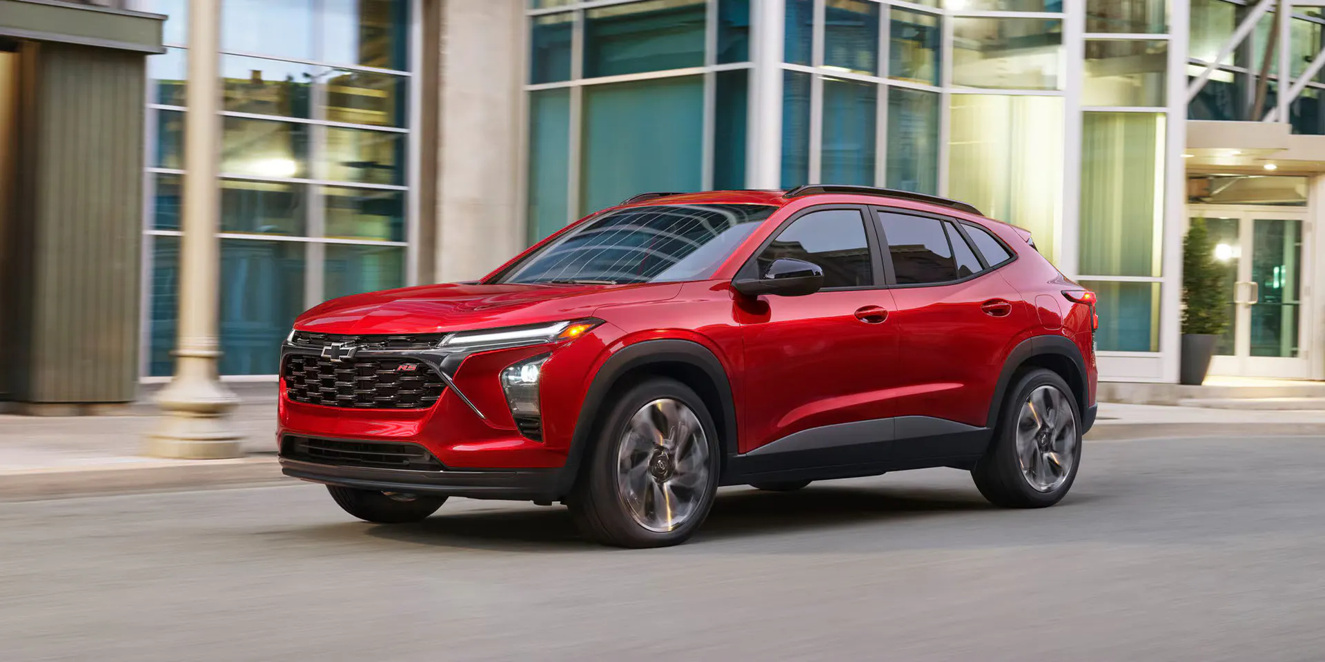 A red trax driving on the road.