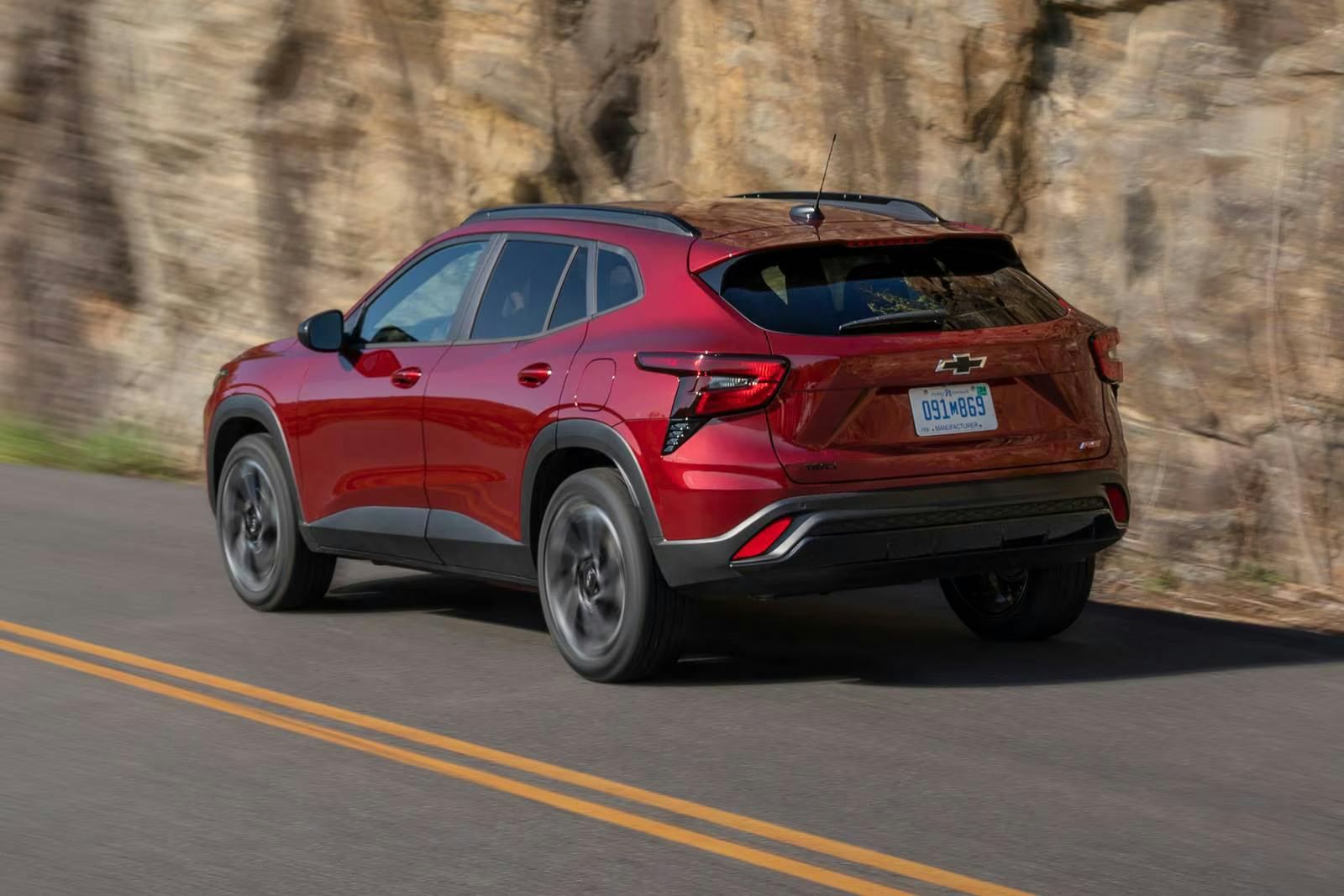 A red trax driving on the road.