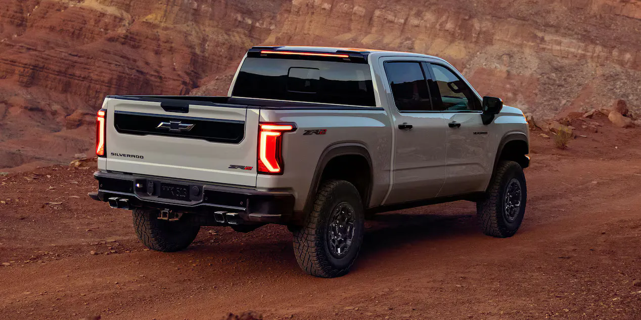 2027-sil-zr2-02 The 2027 Chevrolet Silverado 1500 driving down a dirt road