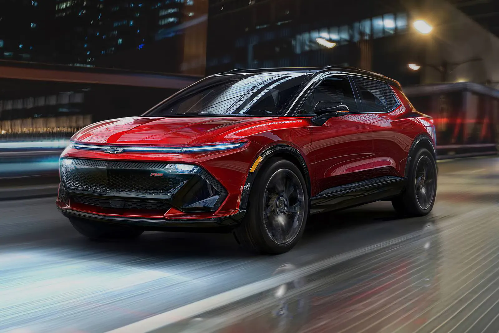 A red equinox ev driving on the road.