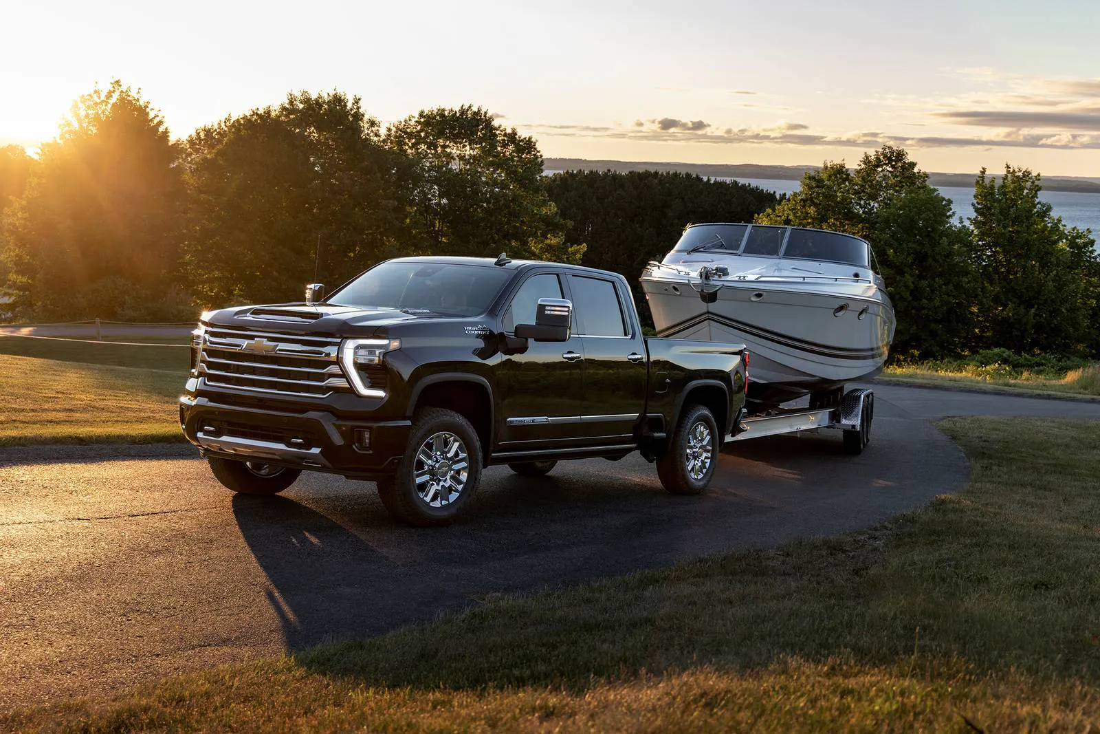 2026_chevrolet_silverado-2500hd_crew-cab-pickup_high-country_life1_oem_1_1600x1067 a view of the new 2026 chevy silverado hd towing a boat